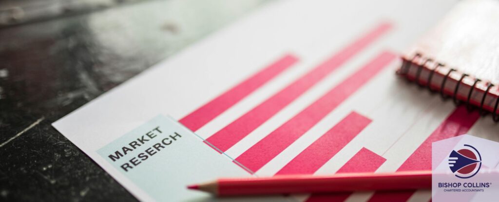 Close up of market research paperwork graphs with a pencil laying across it